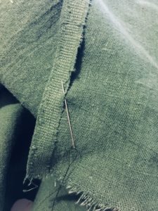 Tacking down the selvage to form the side opening. My stitching is looking a bit better